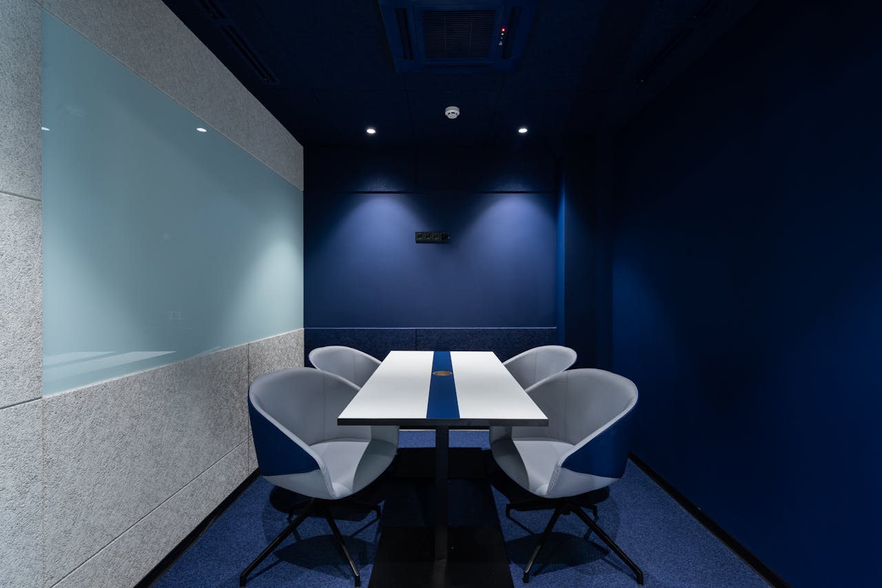A spacious conference room with a table and chairs, ready for meetings and corporate discussions.